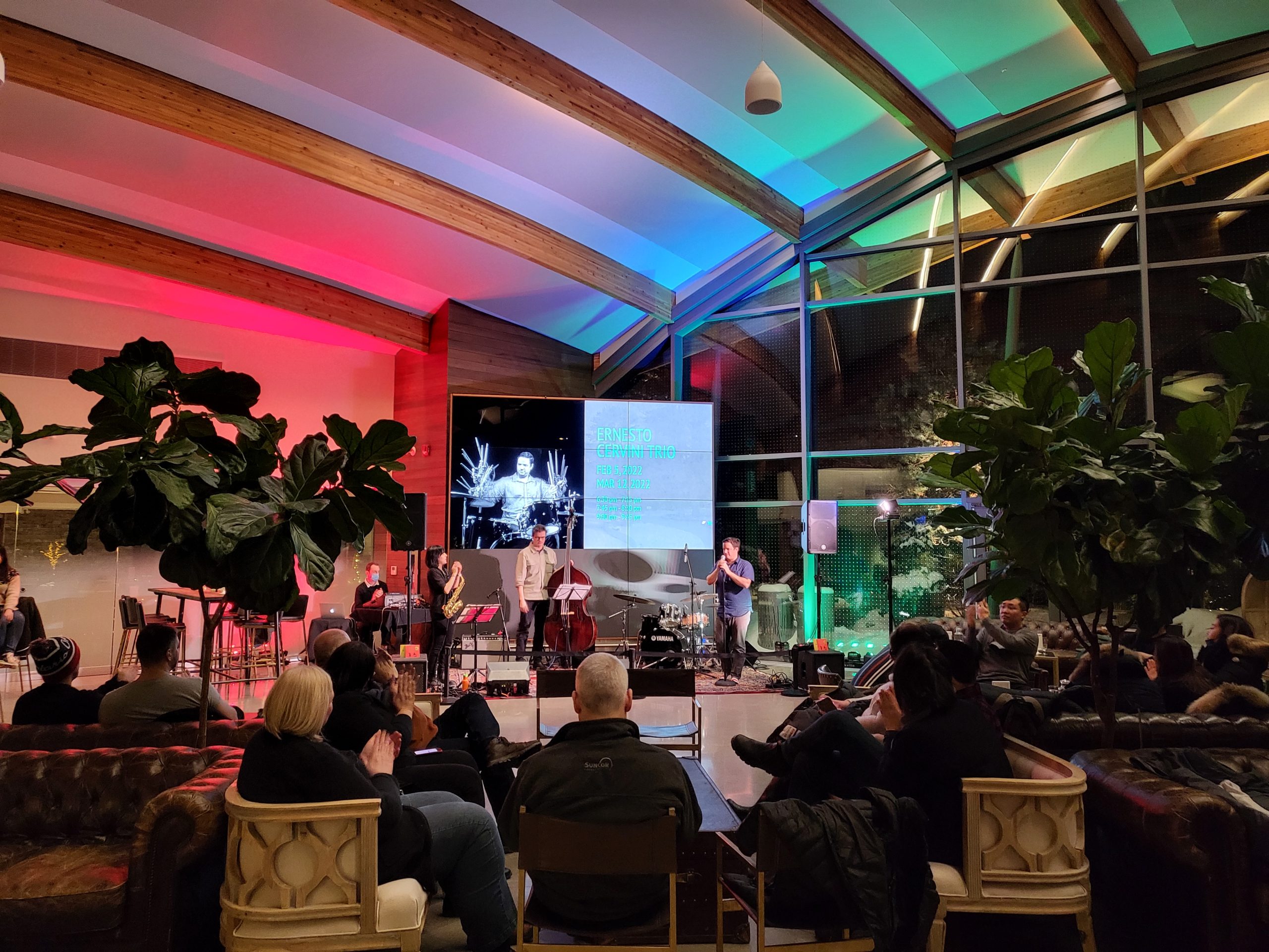 Lounge area full of visitors watching jazz performance