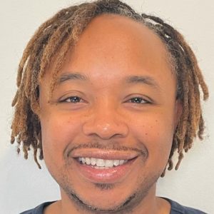 Deon Best • Headshot Headshot photo of Deon Best smiling at camera