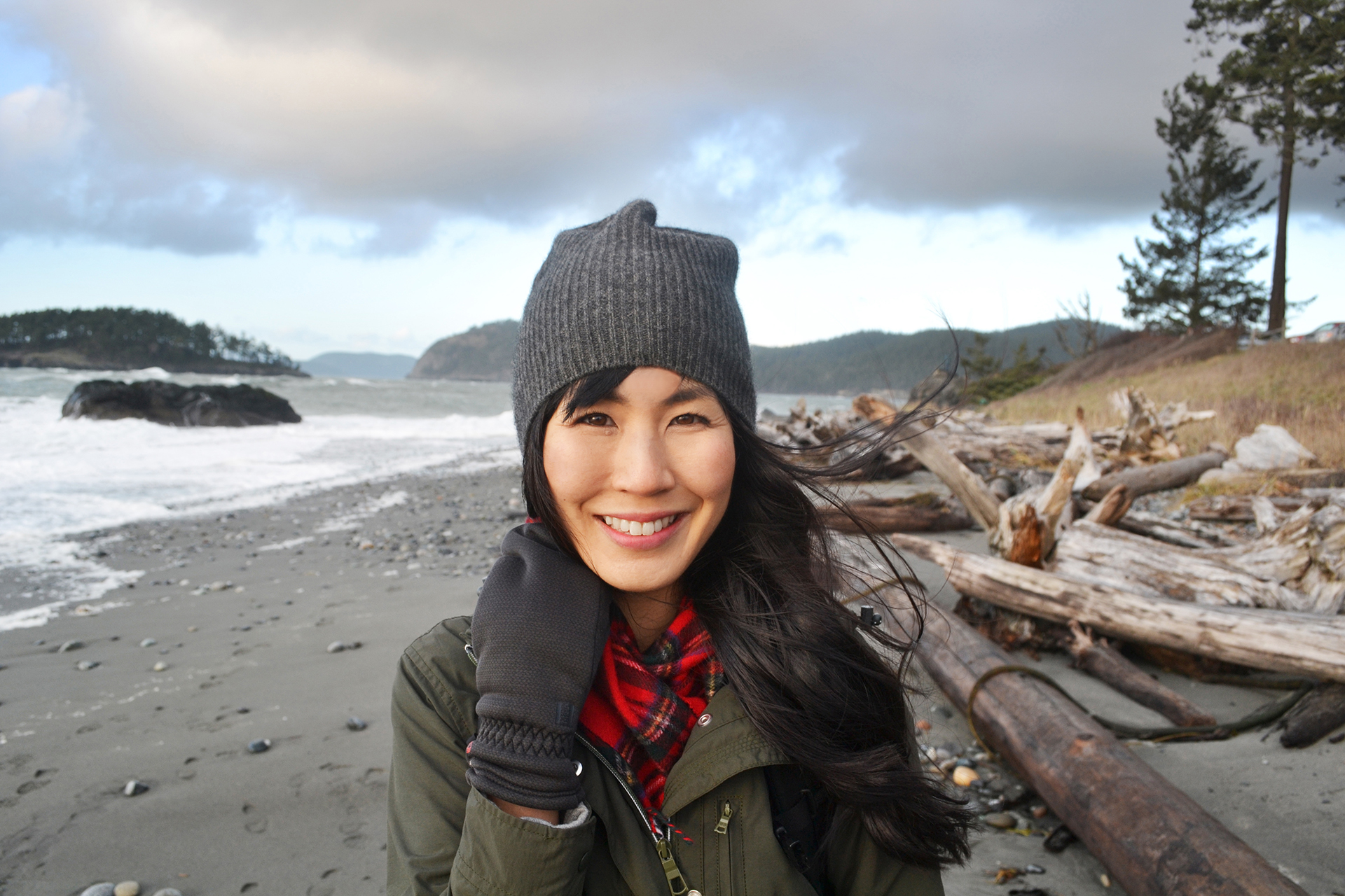 Dr. Melissa Lem standing on a northern rocky beach in winter clothing