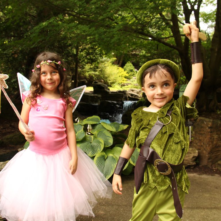 young children dressed as fairies in a garden setting