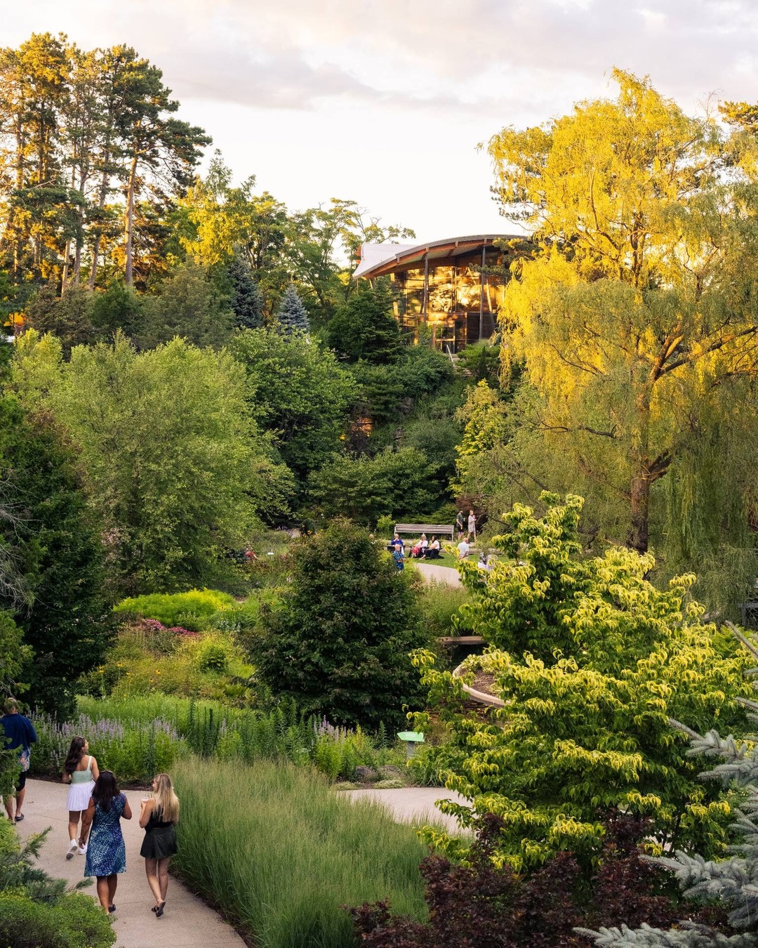 Lower Rock Garden at sunset. Visitors are walking along the winding garden paths