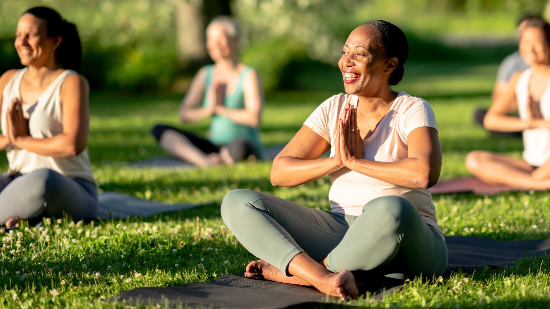group of outdoor yoga in the grass